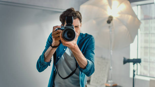 Fashion photographer capturing a model on the runway during a photo shoot